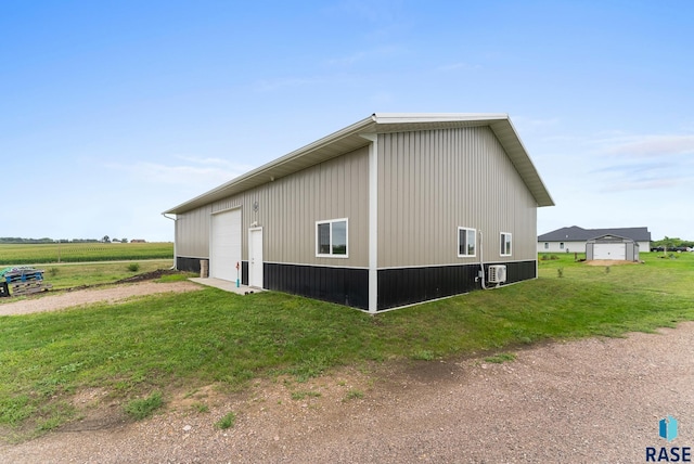 view of property exterior with a lawn, an outdoor structure, and a garage