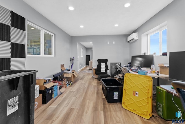 office area with a wall mounted air conditioner and light hardwood / wood-style flooring