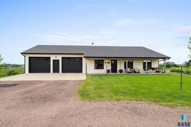 ranch-style home featuring a porch, a garage, and a front lawn