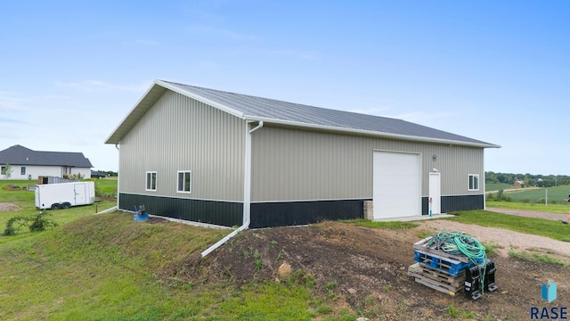 view of home's exterior featuring an outdoor structure and a garage