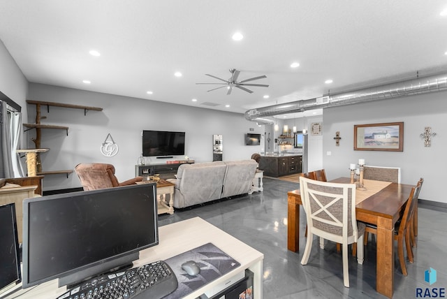 dining space with ceiling fan and concrete floors