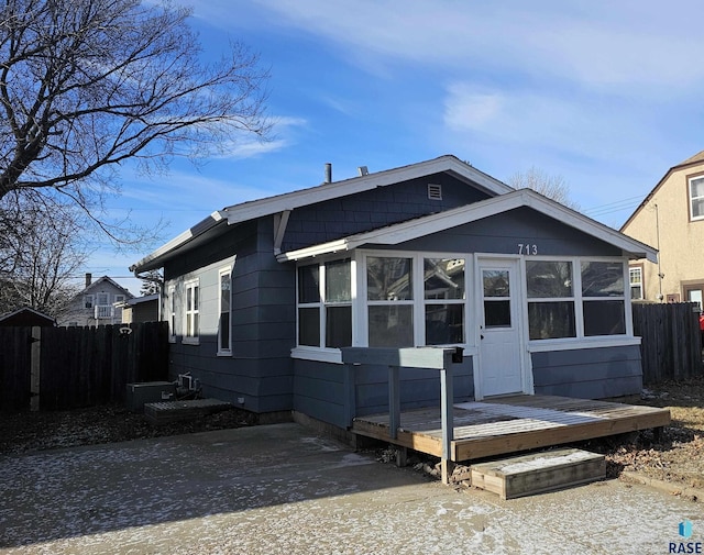 view of front of house with a sunroom and a deck