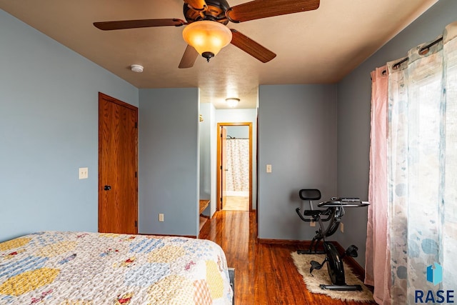 bedroom featuring ceiling fan, hardwood / wood-style floors, and ensuite bathroom