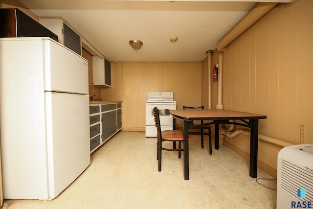 dining area featuring wood walls