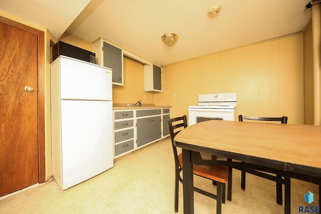 kitchen featuring gray cabinetry, white appliances, and sink