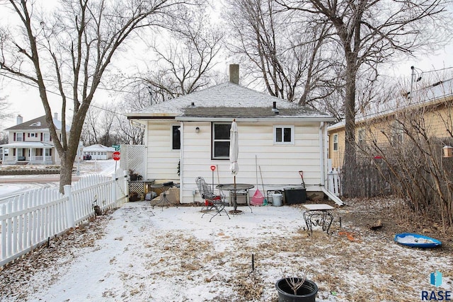 view of snow covered rear of property