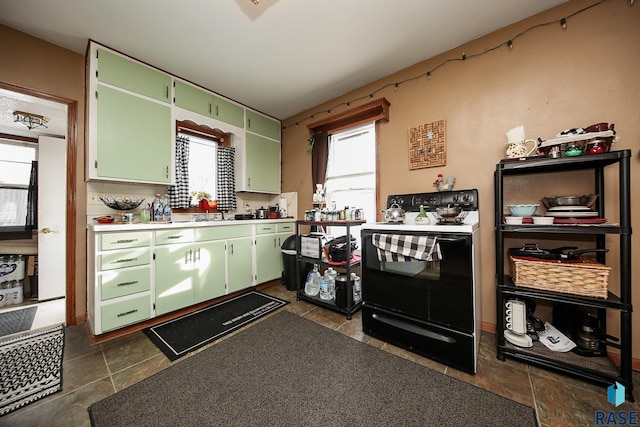 kitchen featuring backsplash, black / electric stove, and green cabinets