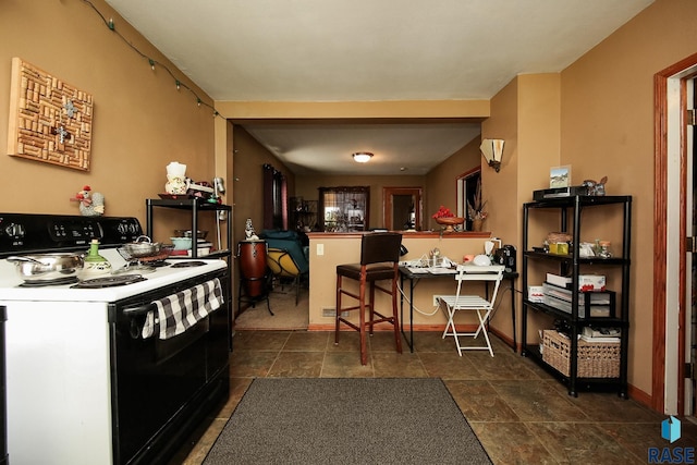 kitchen with a kitchen breakfast bar and white electric stove