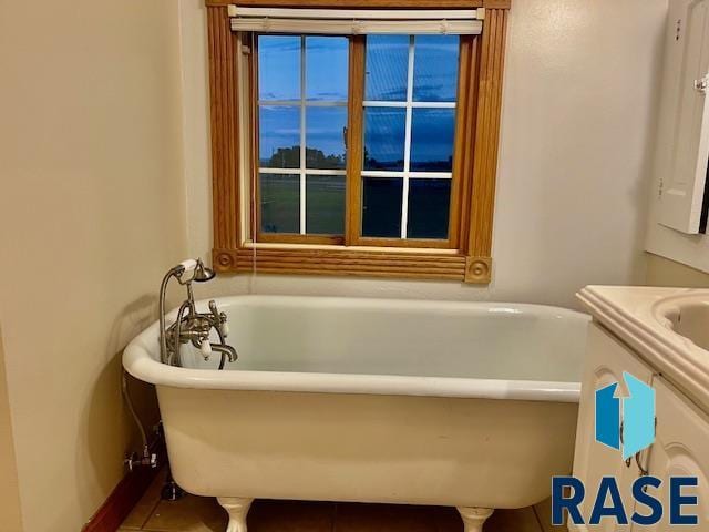 bathroom featuring tile patterned floors and a tub to relax in