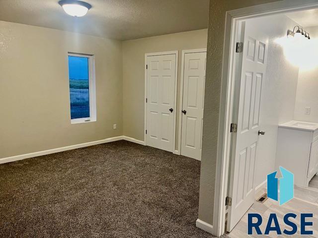 unfurnished bedroom with carpet and a textured ceiling