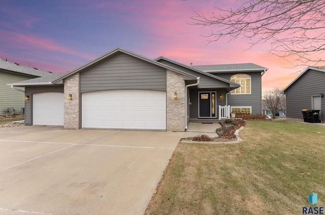 view of front of property featuring a lawn and a garage