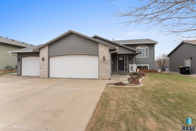 view of front of home featuring a garage and a front yard