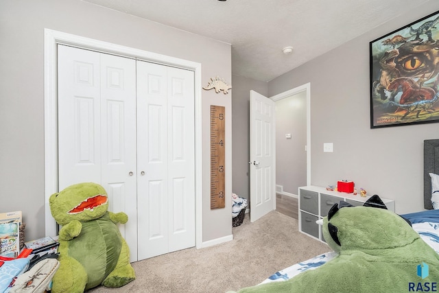 bedroom featuring light colored carpet and a closet