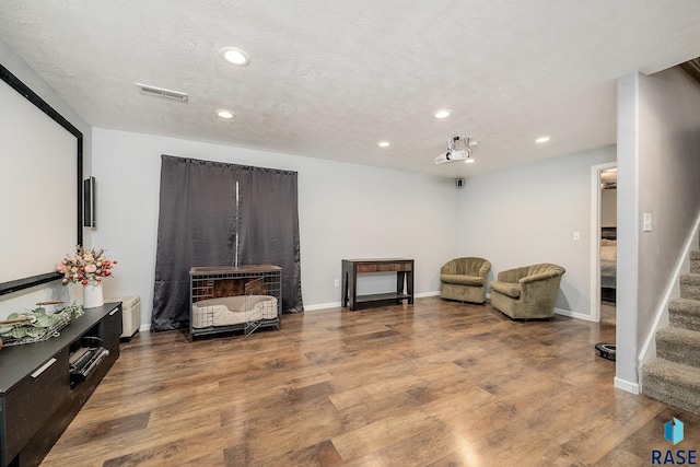 sitting room with hardwood / wood-style flooring and a textured ceiling