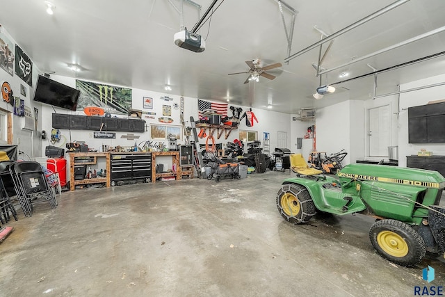 garage with a workshop area, a garage door opener, and ceiling fan