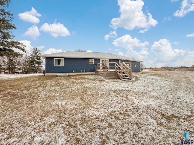 rear view of house featuring a wooden deck