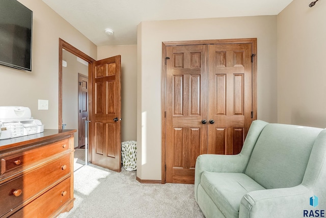 living area featuring light carpet