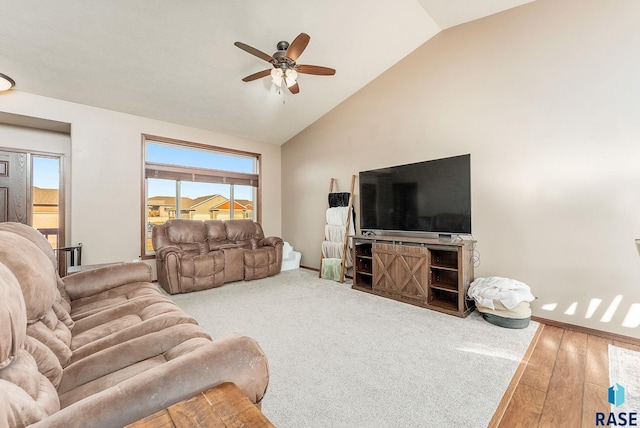 living room featuring ceiling fan, hardwood / wood-style floors, and vaulted ceiling