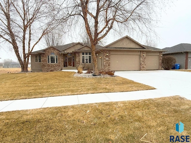 single story home featuring a garage and a front lawn