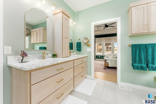 full bath with double vanity, visible vents, a ceiling fan, ensuite bath, and tile patterned floors