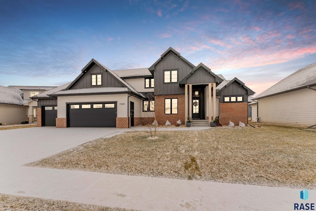 modern inspired farmhouse with board and batten siding, concrete driveway, brick siding, and an attached garage