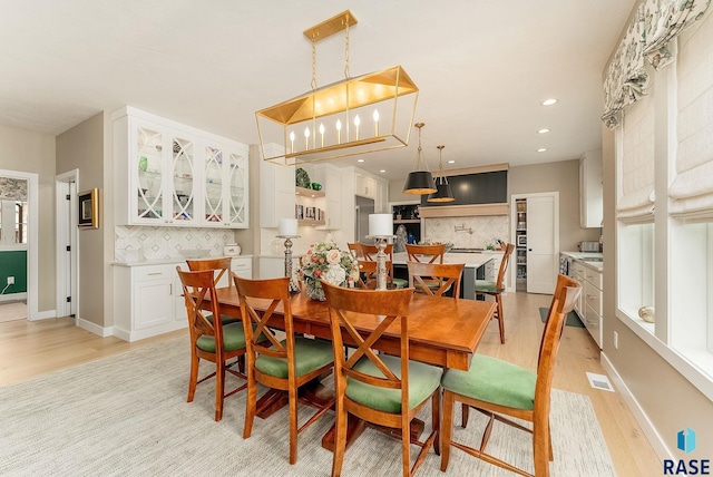 dining space featuring light wood-type flooring, visible vents, baseboards, and recessed lighting