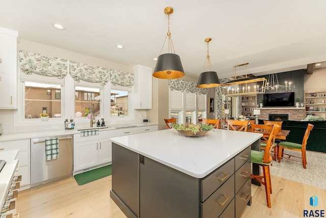 kitchen with white cabinets, a kitchen island, decorative light fixtures, gray cabinets, and light countertops