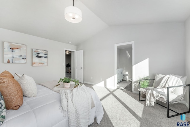 carpeted bedroom with connected bathroom and vaulted ceiling