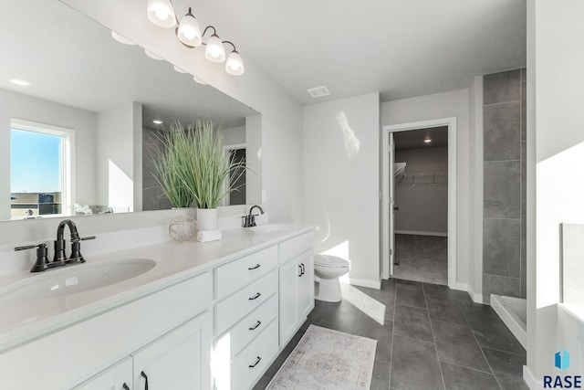 bathroom featuring tile patterned floors, vanity, and toilet