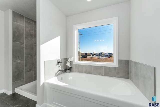 bathroom featuring tile patterned floors and separate shower and tub