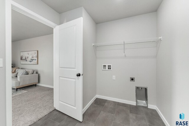 laundry area featuring dark colored carpet, washer hookup, and hookup for an electric dryer