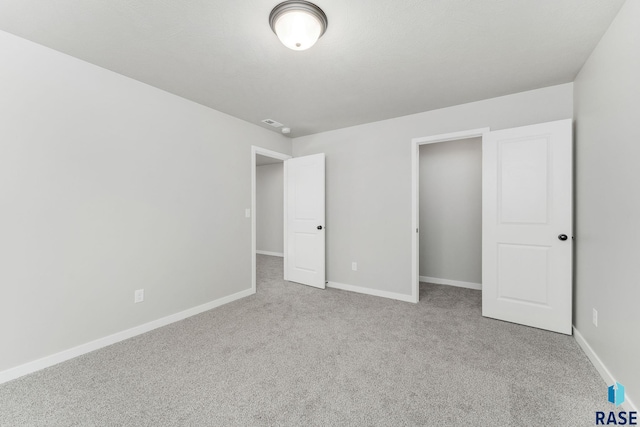 unfurnished bedroom with light carpet