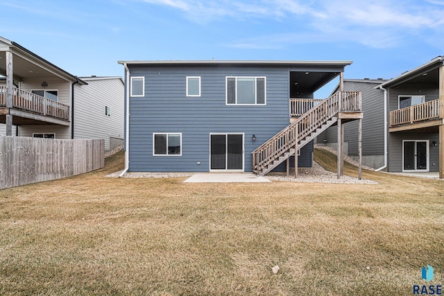 back of house with a yard and a patio