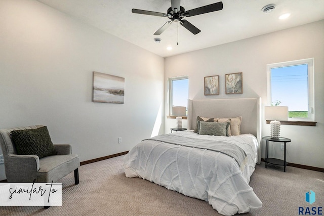 carpeted bedroom with multiple windows and ceiling fan