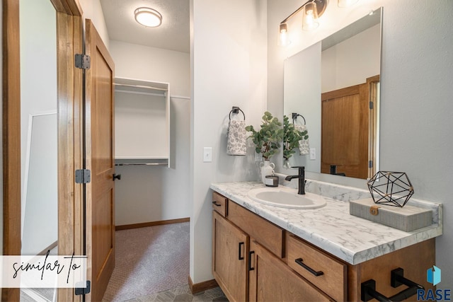 bathroom with vanity and baseboards