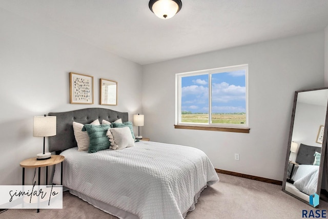 bedroom with light carpet and baseboards