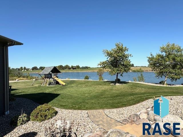 view of yard with a playground and a water view