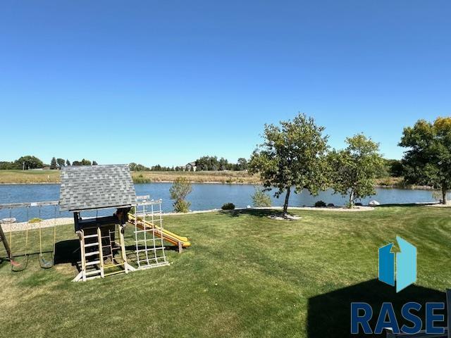 view of yard featuring a water view and a playground