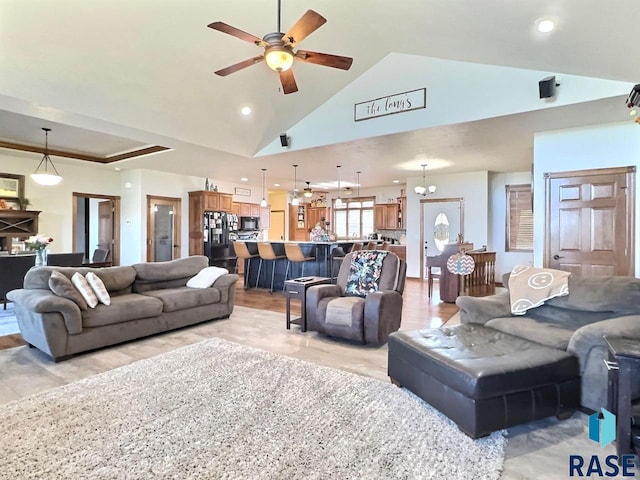 living room featuring ceiling fan and high vaulted ceiling