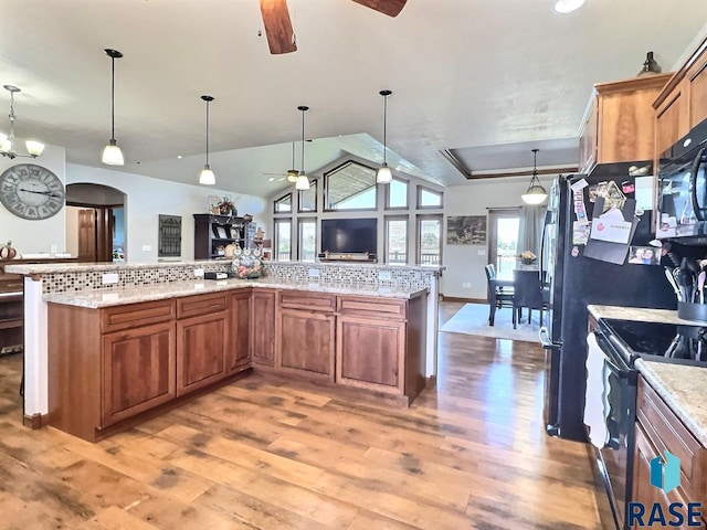 kitchen featuring tasteful backsplash, stainless steel electric range oven, and decorative light fixtures