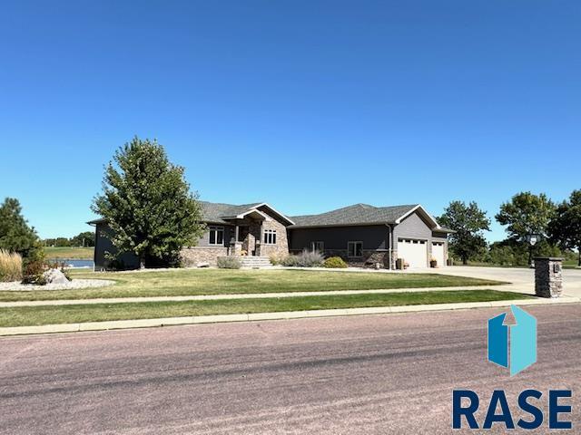 view of front of property featuring a garage and a front lawn