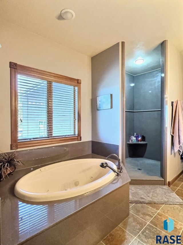 bathroom featuring tile patterned flooring and shower with separate bathtub