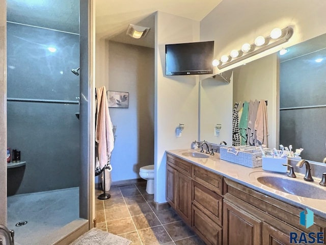 bathroom featuring tile patterned flooring, vanity, and toilet