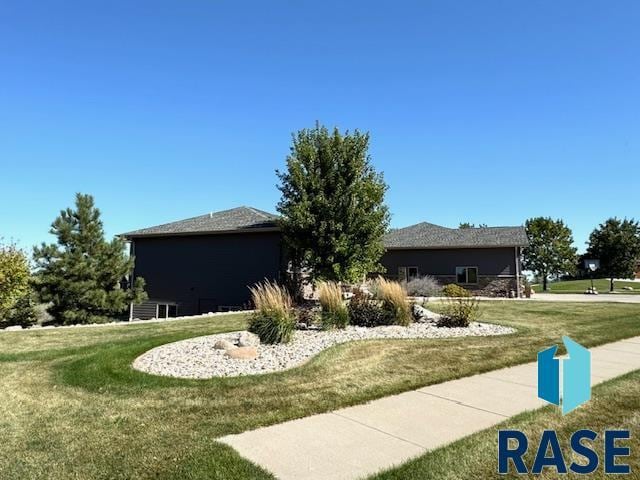 view of property exterior featuring a lawn