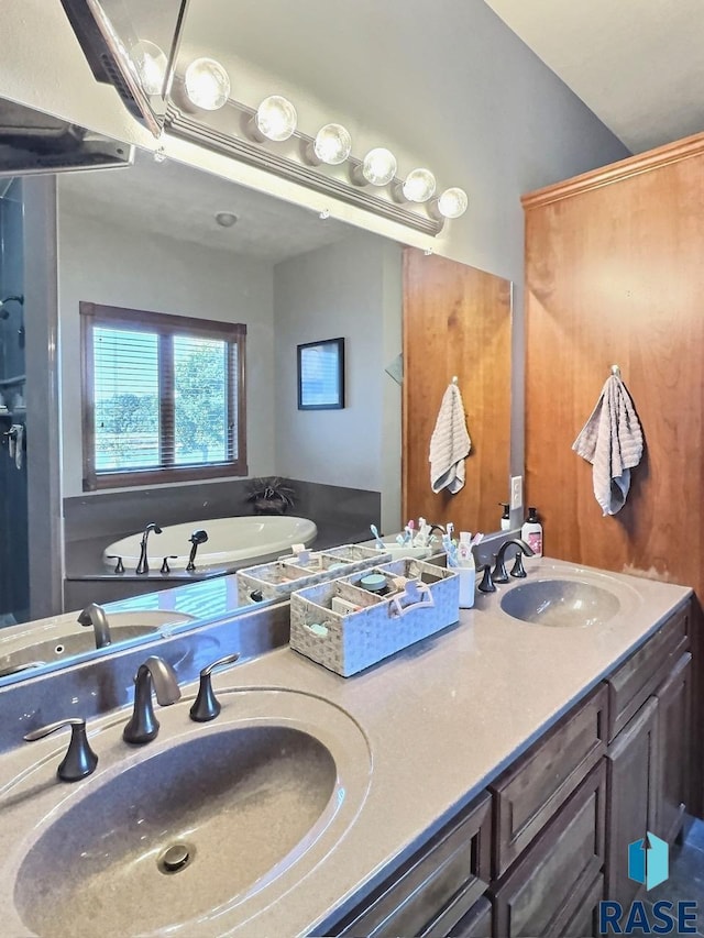 bathroom with vanity and a tub to relax in