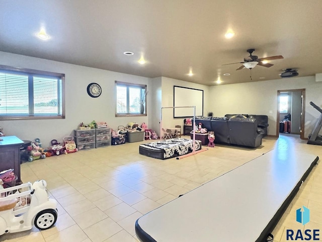 rec room featuring ceiling fan and light tile patterned floors