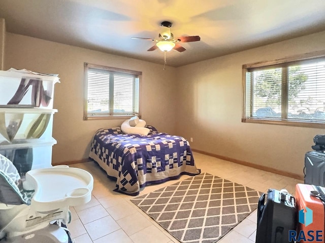 bedroom with ceiling fan and light tile patterned floors