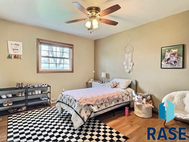 bedroom with ceiling fan and wood-type flooring