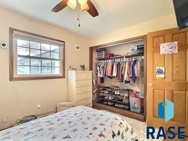 bedroom featuring ceiling fan and a closet