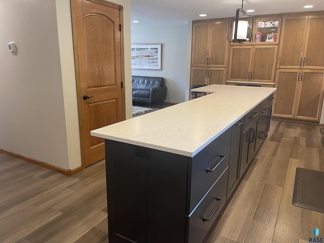 kitchen featuring hardwood / wood-style floors, a center island, and hanging light fixtures